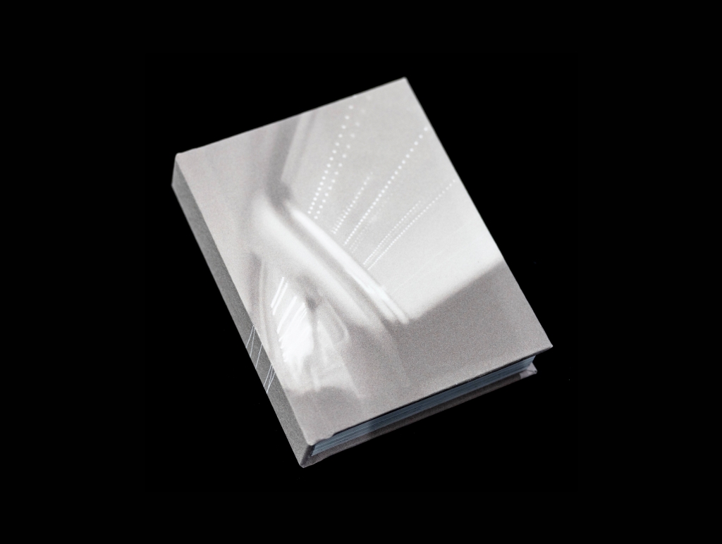 Artist book opened upright on a black background